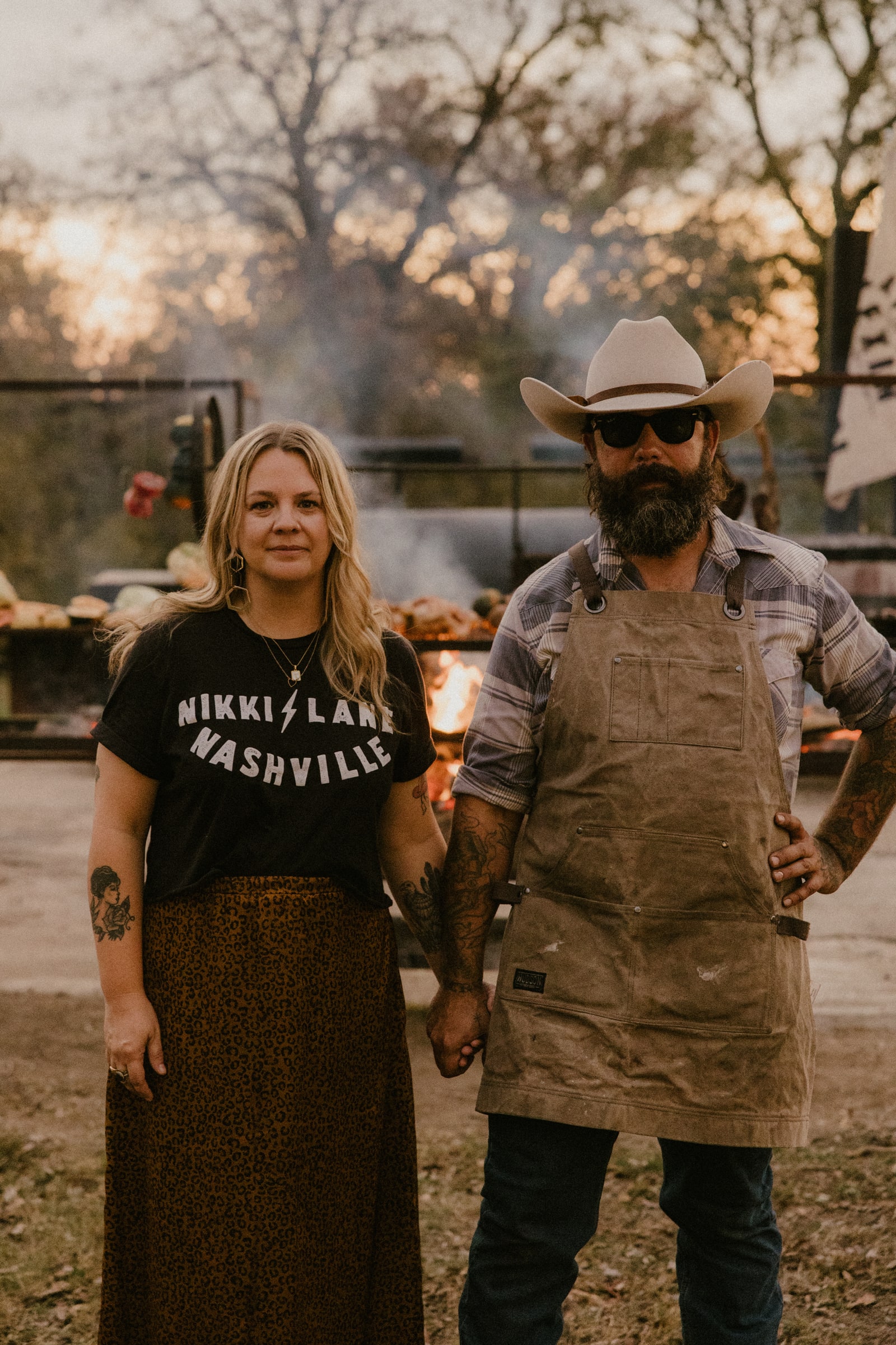 Vanessa and Mike Torres together beside their outdoor cooking setup.