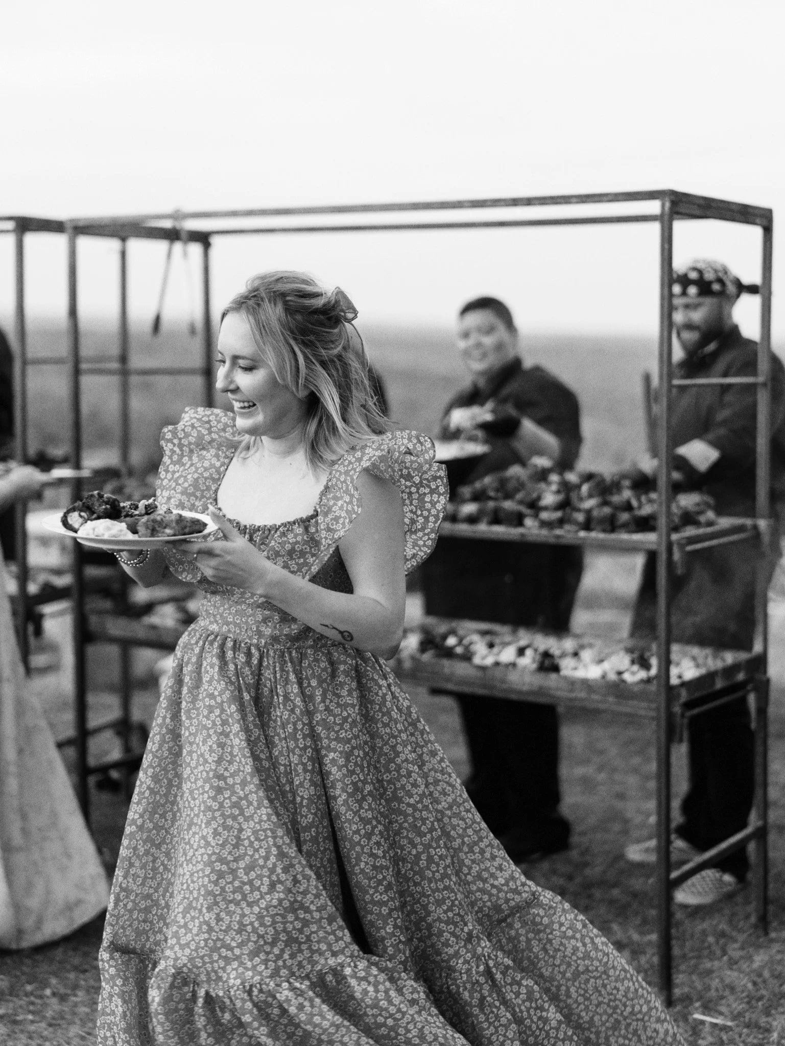 A wedding guest beside Gold Epicure's live-fire cooking rig.